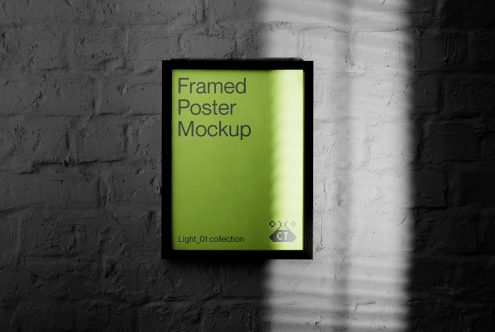 Black framed poster mockup with bright lime green interior on white brick