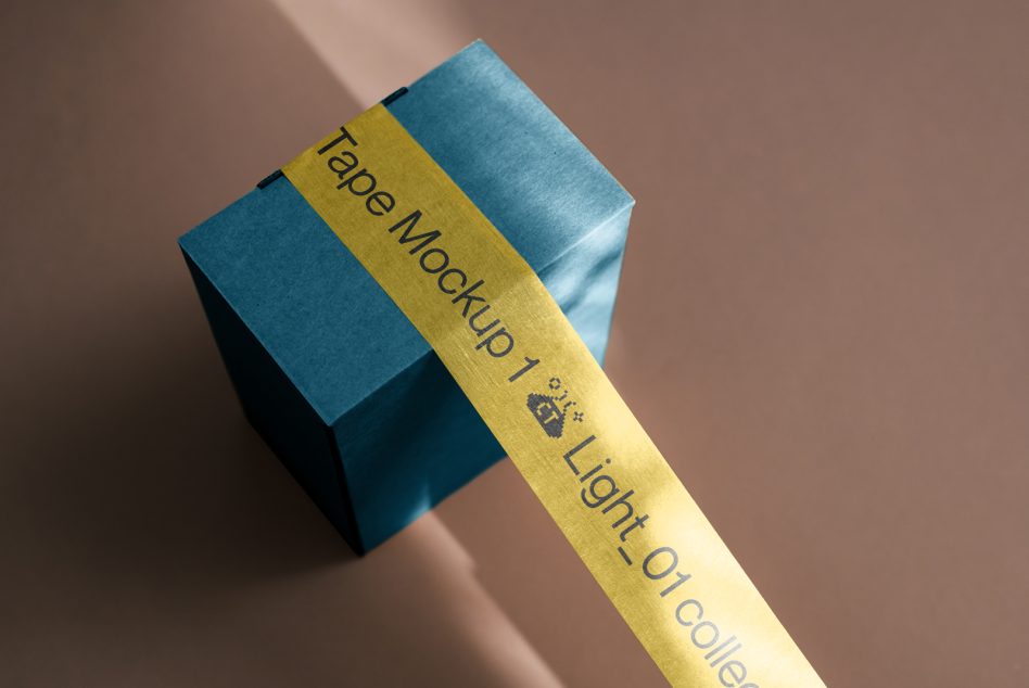 Blue box wrapped with gold band showing text overlay on warm background
