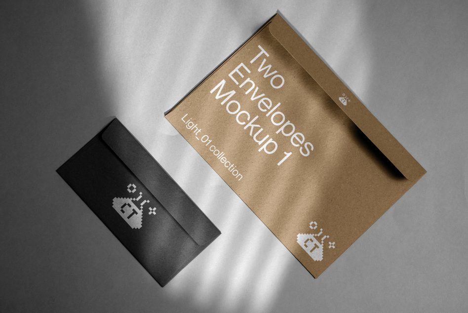 Black envelope beside kraft paper envelope rotated on neutral gray backdrop
