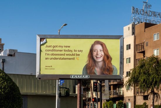Urban billboard mockup with an advertisement featuring a joyful woman, blue sky backdrop, suitable for designers and urban ad presentations.