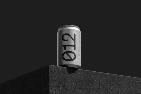 Minimalistic beverage can mockup with condensation on black background, ideal for product packaging designs and branding presentations.