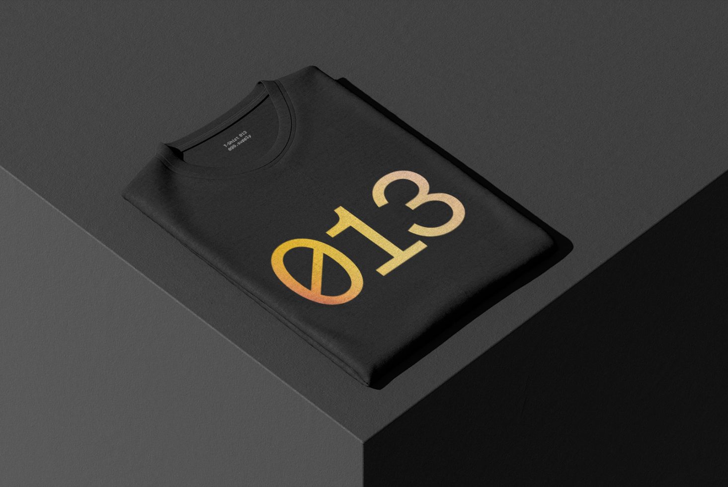 Black t-shirt mockup on a dark background with gold gradient number design, ideal for fashion and apparel graphic presentations.