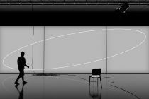 Silhouette of a person in a minimalist interior with dynamic lighting, ideal for graphics or mockups with modern design themes.