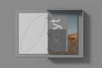 Open bound portfolio with geometric line art on left, landscape photo on right