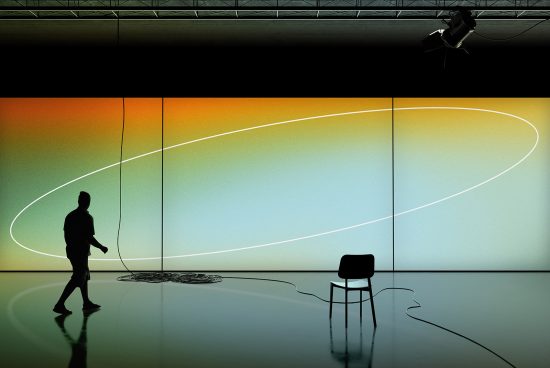 Silhouetted figure in modern art gallery with colorful light installation and chair, ideal for mockups or graphics inspiration.