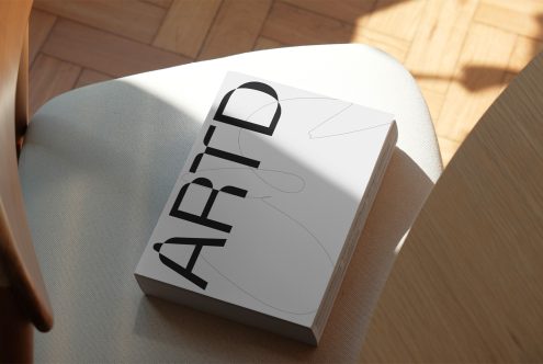 Realistic book mockup on white chair in sunlight for presentation of cover designs and branding, showcasing high-quality textures and lighting effects.