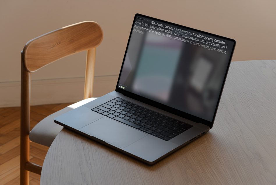 Minimal laptop mockup on wooden table with chair, ideal for website design presentations, digital workspace templates.