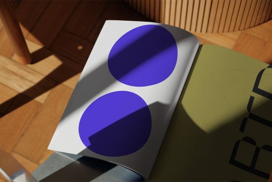 Mockup of a paper sheet with blue circles in a sunlit room, ideal for presentations, graphic design portfolio.