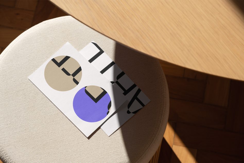 Stacked branding cards with geometric circles in cream, blue, plus black striped shapes on cream chair