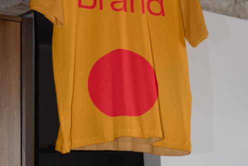 Close up of yellow shirt fabric with red apple shape