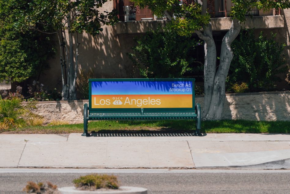 Green bench with blue orange gradient ad displaying Los Angeles branding in sunny park setting