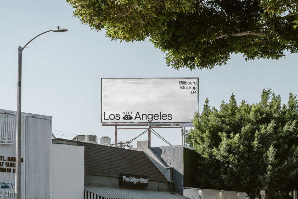 White billboard mockup with Los Angeles text framed by green tree canopy
