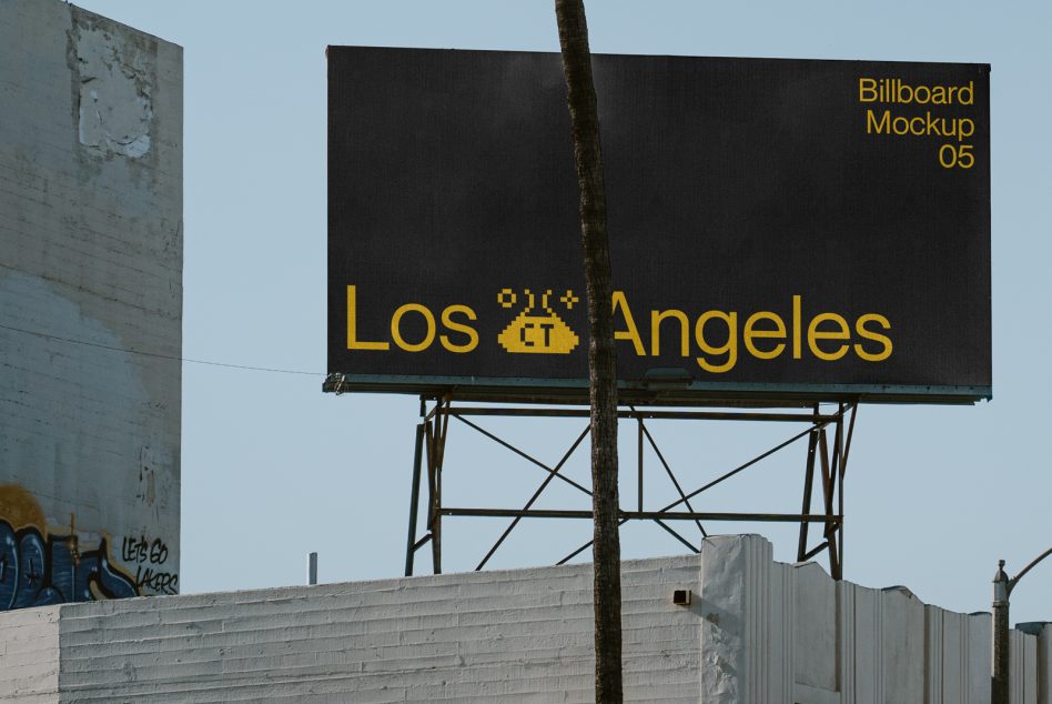 Black billboard with yellow Los Angeles text on industrial metal structure