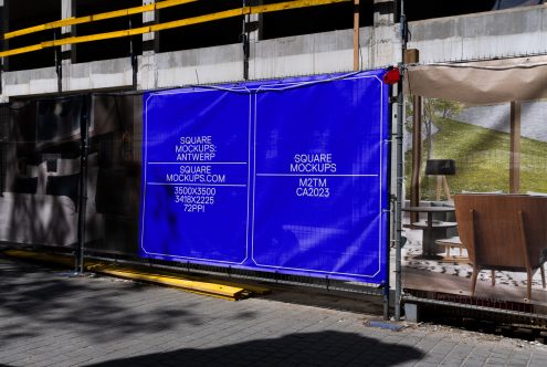 Bright blue neon glowing square panels on metal fence barrier