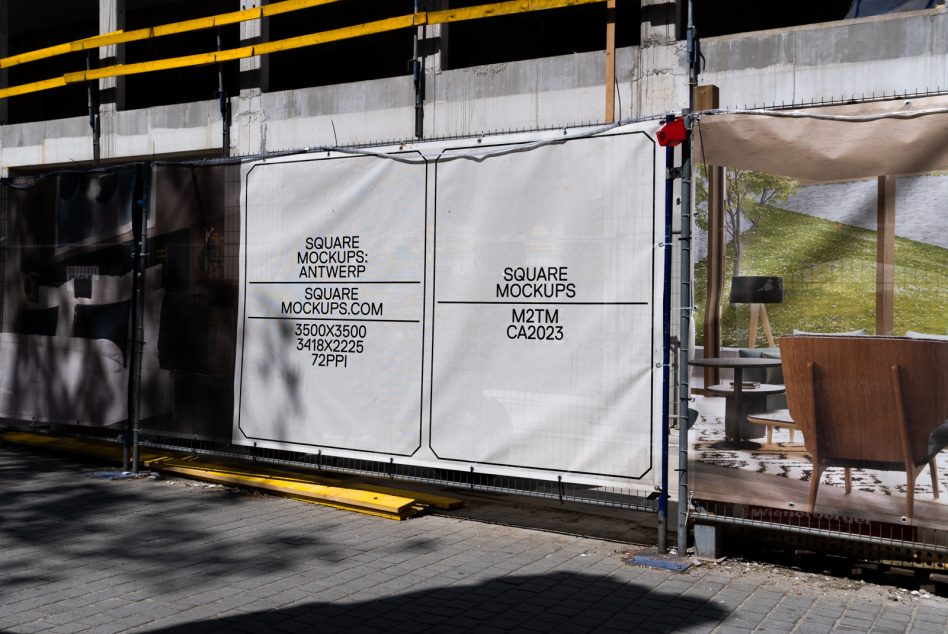 Two white square panels on construction site hoarding with black text