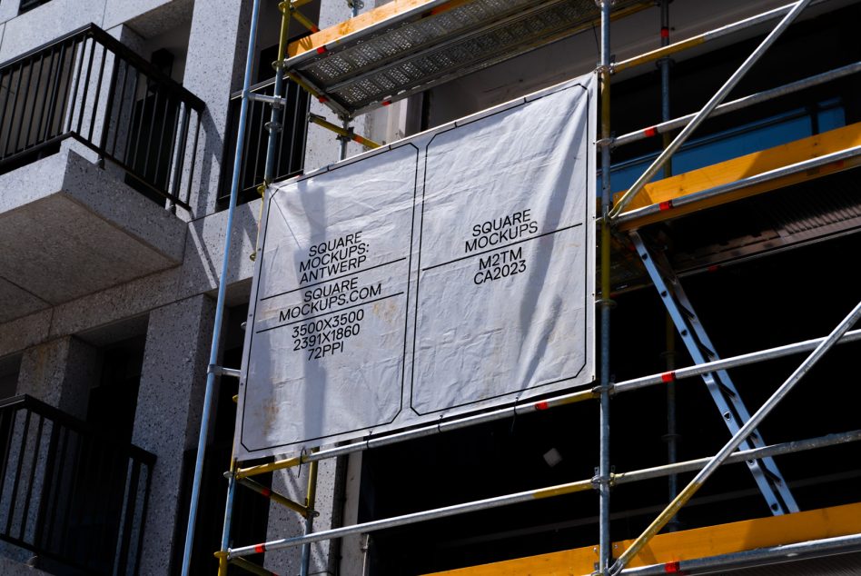 White fabric banner mockup hanging on construction scaffolding frame