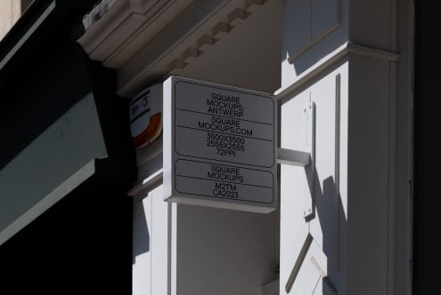 Dark gray square signage mockup mounted on modern building exterior