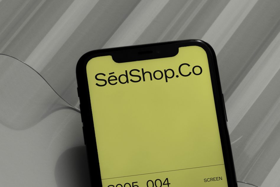 Yellow phone display with SedShop.Co branding on subtle striped surface