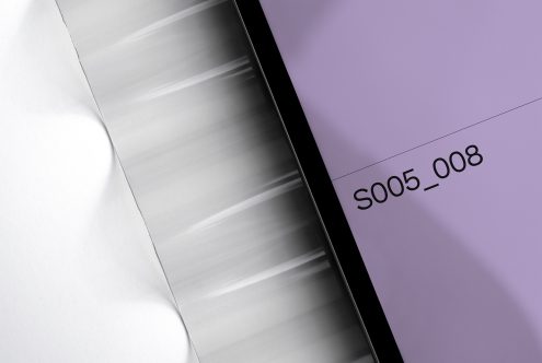 Tablet displaying purple screen with product code on lavender paper backdrop