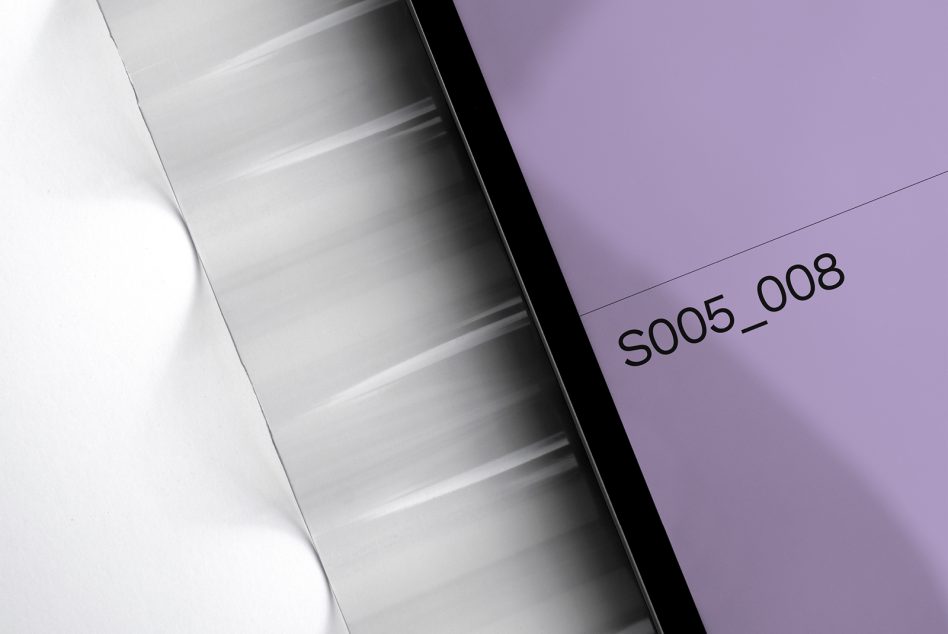 Tablet displaying purple screen with product code on lavender paper backdrop