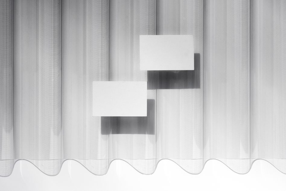 Blank white business cards floating against sheer curtain with soft shadows