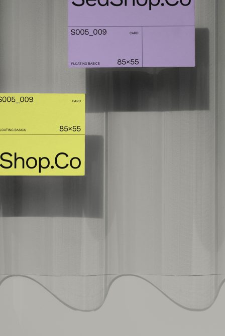 Colorful business cards in purple, pink, yellow overlapping on textured background