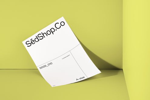 White A-size business card mockup on lime background with angled placement