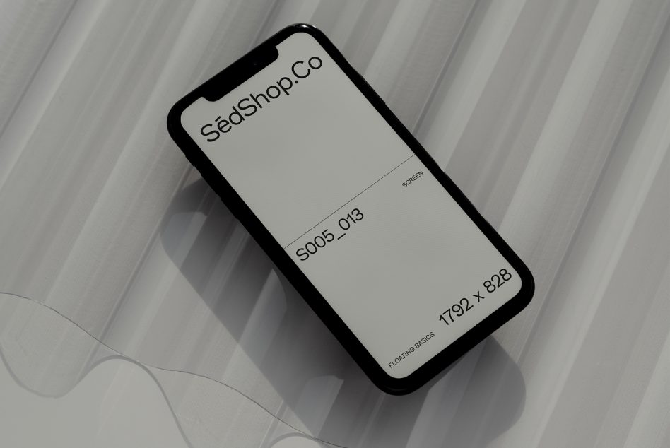 iPhone mockup displaying SédShop.Co branding on lined gray background