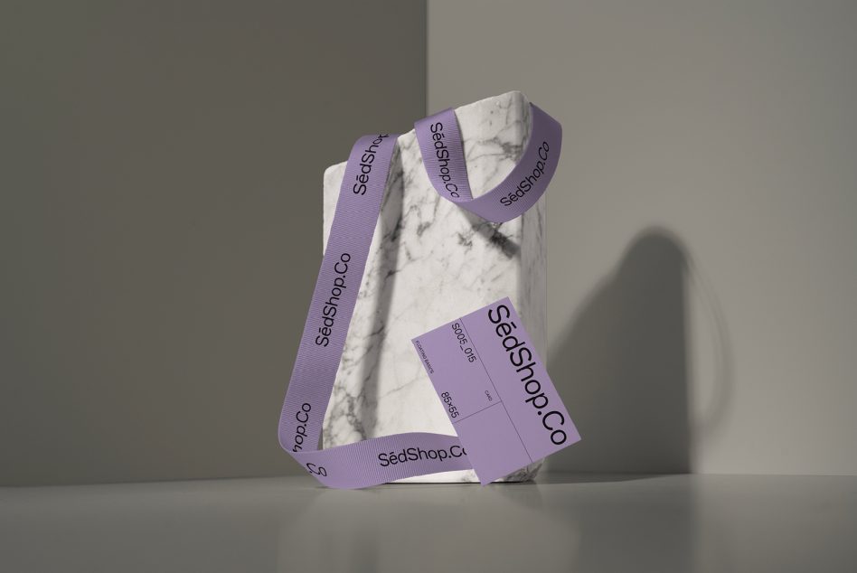 Marble box wrapped in purple branded ribbon with SedShop.Co business card attached