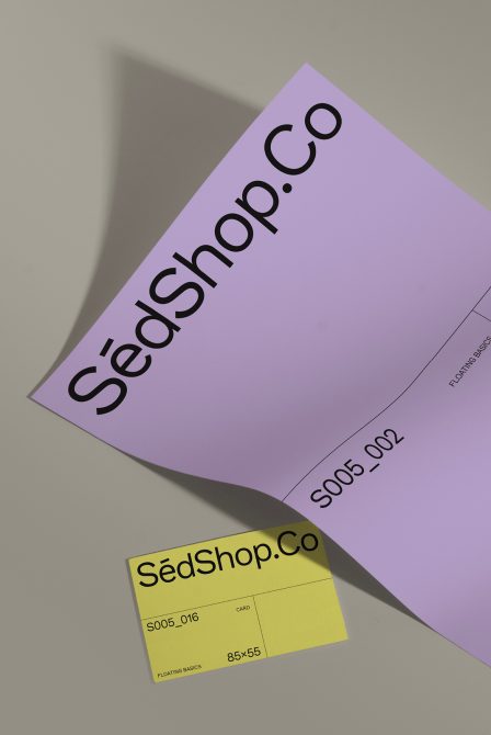 Lavender folded brochure with SedShop.Co branding next to small yellow business card