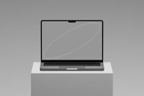 Gray laptop on white block with neutral desktop mockup