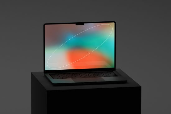 Laptop on a dark podium with a colorful abstract screen design, showcasing modern mockup for presentations and digital branding.