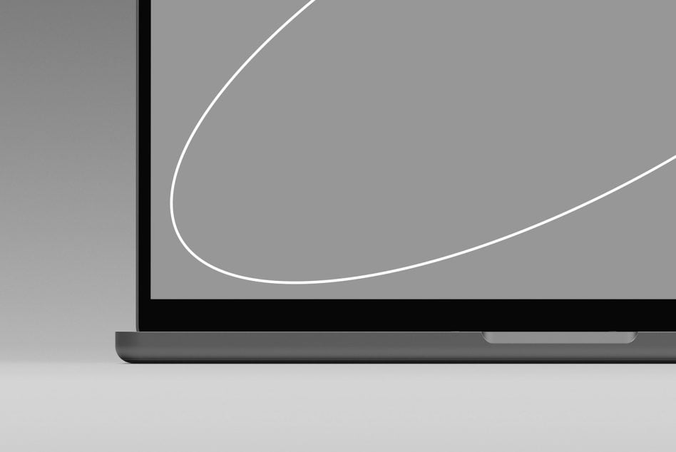Laptop bottom corner detail with black bezel, white curved line visible