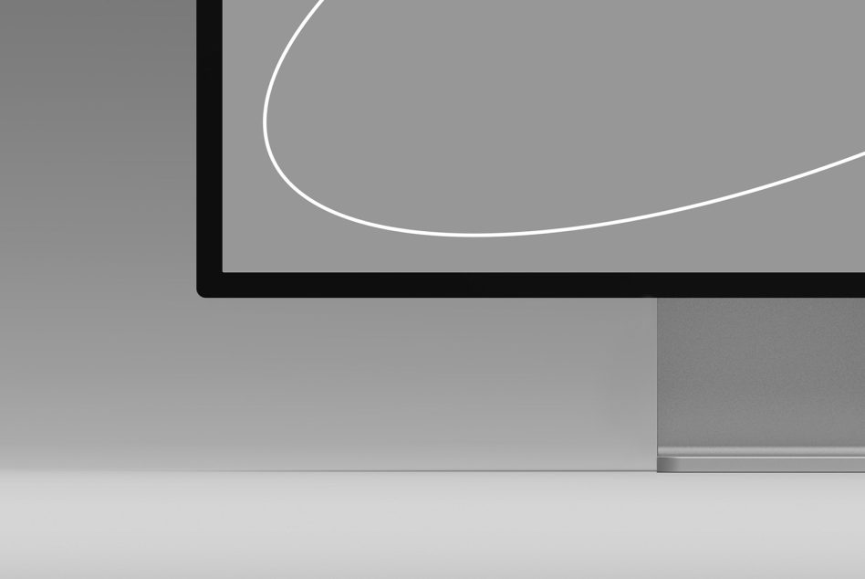 Minimalistic computer monitor mockup in a gray scale setting, perfect for presenting digital designs and user interfaces to clients.