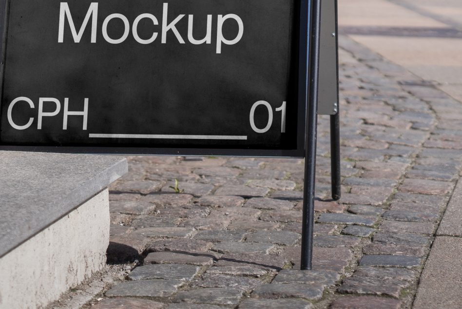 Black sidewalk sign with white text showing A-Frame Mockup CPH 01