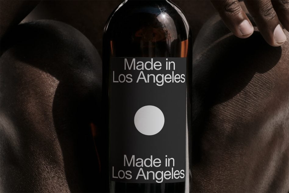 Dark wine bottle with Made in Los Angeles label held in hands