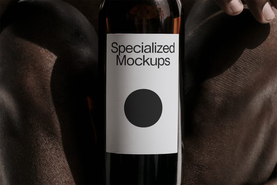 White wine bottle label mockup held in hands against dark fabric backdrop
