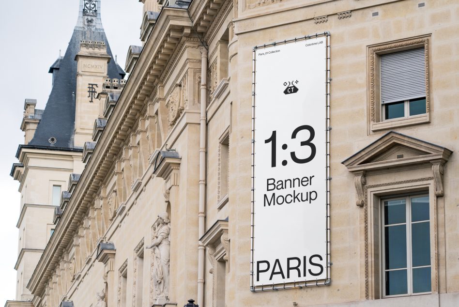 Tall white banner with black text on classical architecture with slate roof visible