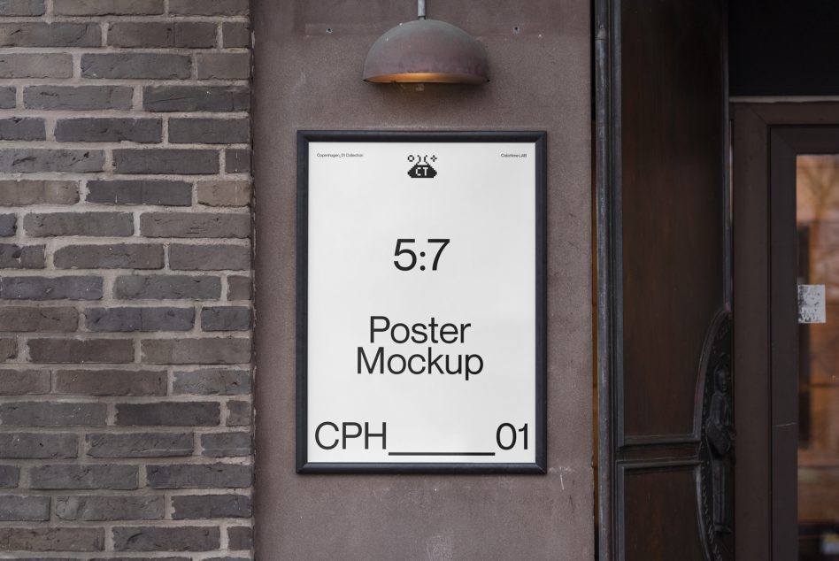 Framed poster mockup on dark brick wall with dome lamp, white background