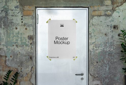 A2 poster frame with light background held by brass clips on weathered door