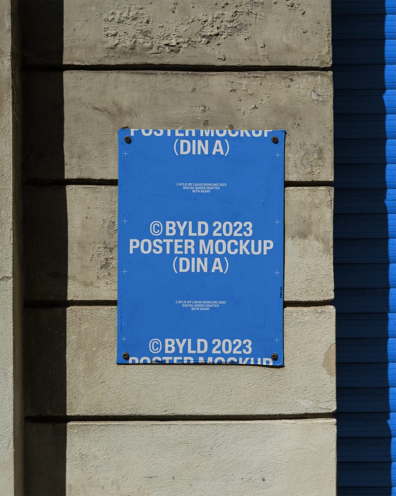 Blue urban poster mockup on a textured wall, sunlight casting shadow, realistic display for designers' graphics presentations.