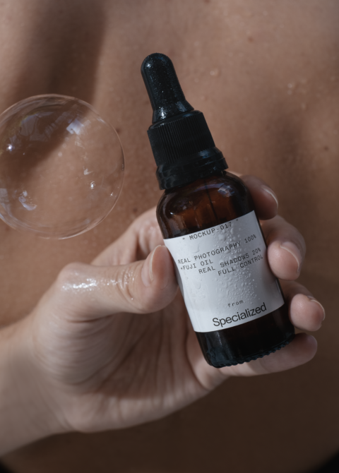Close-up of amber glass dropper bottle with detailed label text in natural lighting