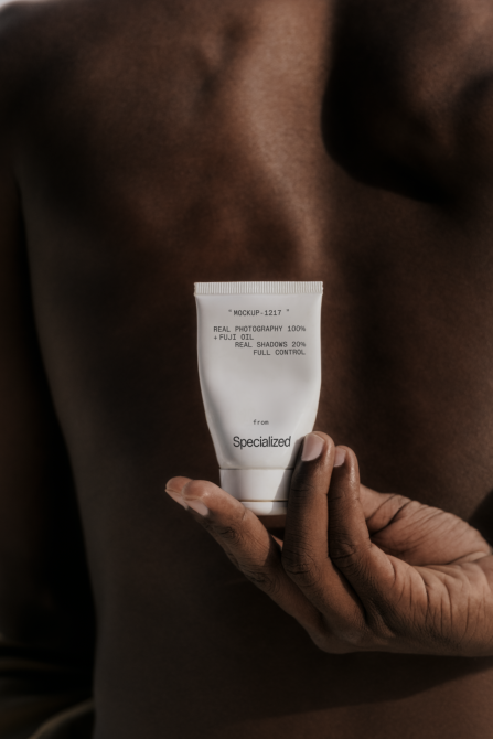 White cosmetic tube with technical specs text held in hand