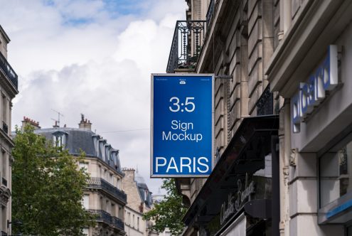 Vertical blue sign hanging from Paris storefront with 3.5 ratio format