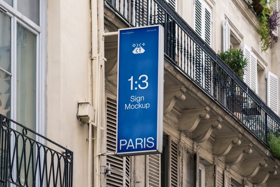 Blue vertical sign hanging on Parisian building facade showing 1:3 ratio mockup