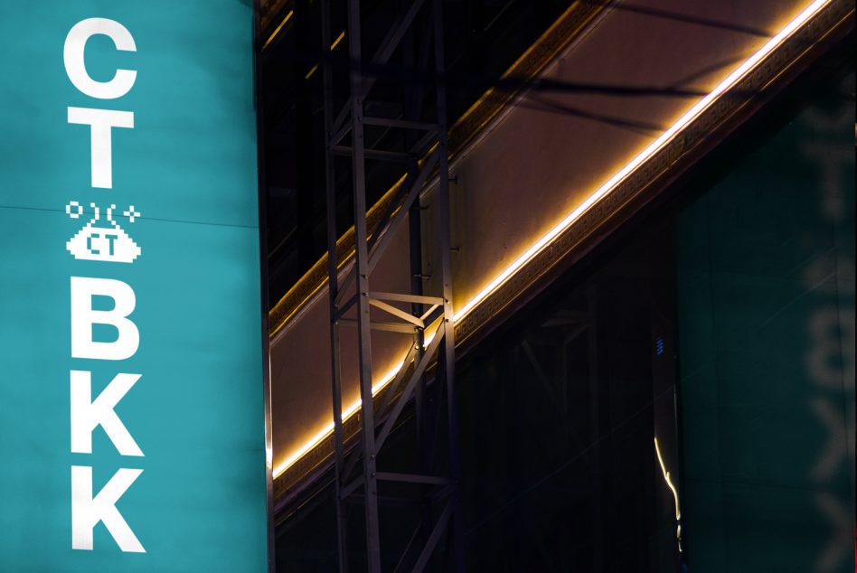 Vertical teal sign mockup showing stacked CT BKK letters with neon accent lighting