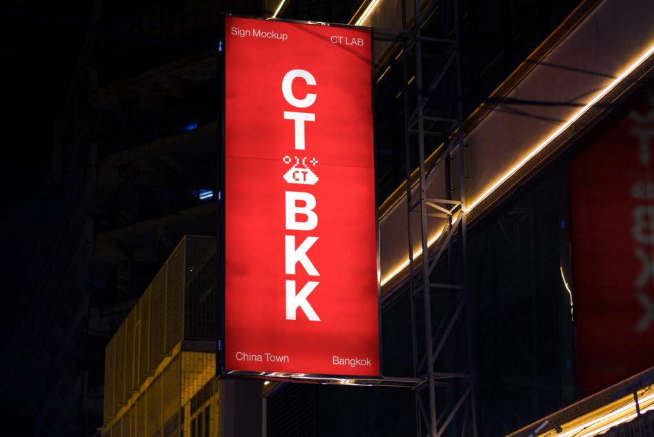 Tall red vertical sign at night with stacked white letters spelling out CT BKK in Bangkok's Chinatown