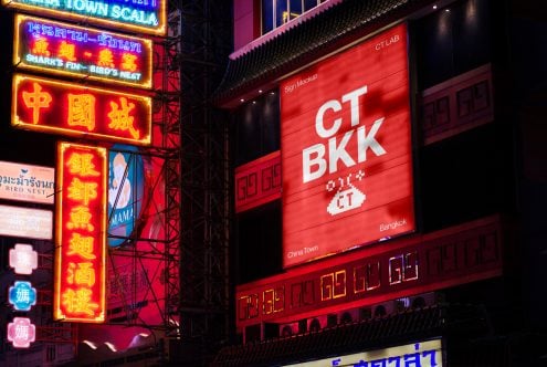 Red horizontal sign mockup displaying CT BKK logo amid glowing neon surroundings
