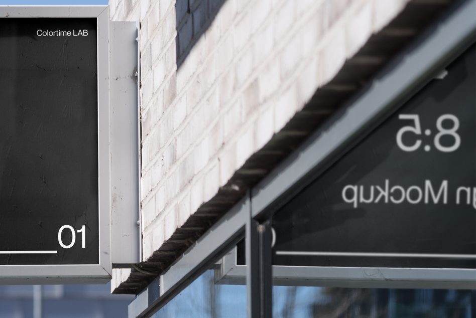 Close up of exterior sign with white text on dark background in sunlight