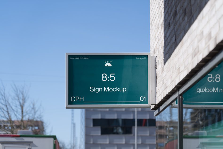 Horizontal sign mockup with teal background against brick building